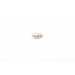 An 18ct gold sapphire and diamond dress ring The circular shape sapphire and rose cut diamond line