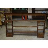 An 18th Century oak dresser rack With a dentil cornice above two central shelves flanked by