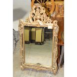 A 19th Century style gilt metal wall mirror, 20th Century Having an openwork pediment cast as