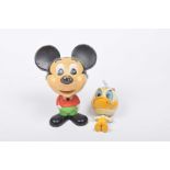 Two 1970s plastic Disney figures Comprising a Mattel Inc. 1976 Mickey Mouse figure with pull