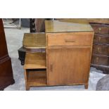 A 1930's Art Deco side cabinet Having a single frieze drawer above a cupboard door opposed by a