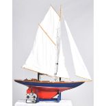 A good quality model yacht With red and blue hull and plank effect decking, fully rigged with single