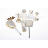 A selection of silver To include silver backed brushes, a silver candlestick, silver lidded jars and