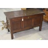 An 18th Century oak coffer The rectangular two plank top enclosing a fitted candle box above three