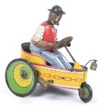 A tinplate clockwork Lehmann tricycle In red and yellow, with green and yellow wheels, with a