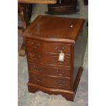 A reproduction mahogany serpentine chest of small proportions The cross banded serpentine top