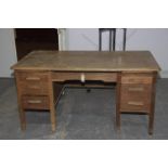 A mid 20th Century office desk The rectangular top with rounded corners above an arrangement of