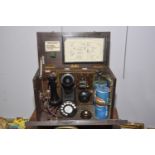 A wooden cased operators telephone, mid 20th Century With dialing pad, batteries, bell, speaker &