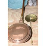 A group of two metal ware items To include a copper bed warmer with etched design and wooden