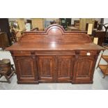 A Victorian mahogany inverted breakfront sideboard The rectangular top with a raised back above