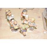 A group of five Hummel figures The figures in typical glaze depicting young children playing,