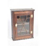 An 18th Century glazed oak cabinet Having a single astragal glazed door enclosing two shelves, the