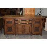 A late Victorian walnut sideboard Having a rectangular moulded top above an arrangement of two