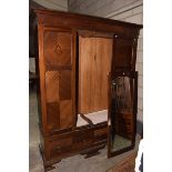 An Edwardian mahogany wardrobe Having a cavetto cornice above a single mirrored door and two drawers