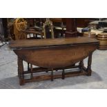 A good quality 17th Century style wake table, 20th Century The oval drop leaf top raised upon ring