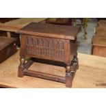 A 17th Century style hinged box stool, 20th Century Having a rectangular hinged cover above chiseled