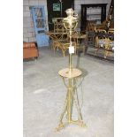 An early 20th Century brass lamp standard Having a converted brass reservoir raised upon a