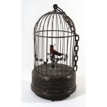 A Victorian bronze effect automation bird cage With singing musical bird, height 28cm