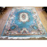 A large Chinese wool floor rug Decorated with central floral medallion, on a blue background