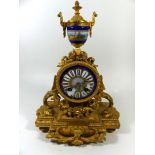 A 19th Century French gilt metal and porcelain mounted mantel clock Of architectural form, the