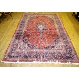 A large 20th Century Caucasian floor rug Decorated with a central red panel with flowers