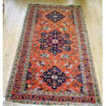 A 20th Century Caucasian wool floor rug Decorated with large central panel of stylised floral motifs