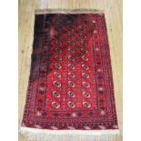 A 20th Century Bokhara type wool floor rug Decorated with a large central geometric panel,