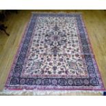 A Royal Keshan wool floor rug Decorated with large central panel with floral motifs on a beige