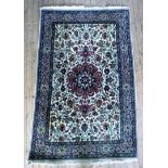 A 20th Century Iranian wool floor rug Decorated with central floral panel on beige background