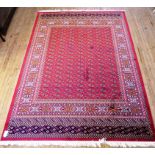 A Bokhara rug Decorated with geometric design on a red background, 2.8x2.0m