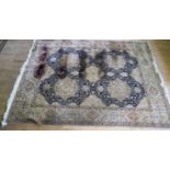 A large 20th Century Afghan style wool floor rug Decorated with central blue medallions on a beige