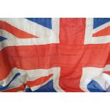 A sewn Hessian Union Jack, 20th Century Union Jack with wooden toggle and rope end, 126x245cm (af).
