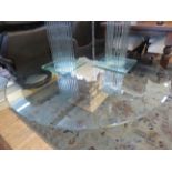 A large modern coffee table with short pedestal base and circular bevelled glass top