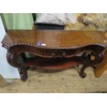 An early 20th Century mahogany console table, the serpentine top with a gadroon border and a