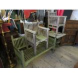 Four items of hardwood garden furniture to include a slatted bench, a conforming pair of chairs