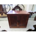 An early 20th Century mahogany two door cabinet with a vacant interior