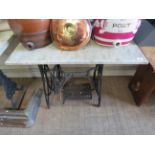 A Singer iron treadle frame with marble top