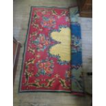 A classical foliate pattern rug/wall hanging upon a red ground