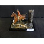 A painted spelter metal desk ornament formed as a huntsman on horseback with accompanying hound