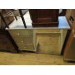 A painted three drawer dressing table