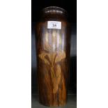 A turned wooden vase decorated with pen work design of irises.
