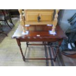 A 1930's oak occasional table on barley twist supports