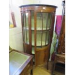 An Edwardian inlaid mahogany bowfront display cabinet on slender outswept legs