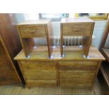 A contemporary hardwood sideboard of six drawers along with a pair of conforming single drawer