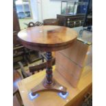 A mid 19th Century rosewood pedestal table, the circular top raised on a ring turned shaft with