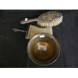 A sterling silver circular sugar basin together with two silver backed brushes.