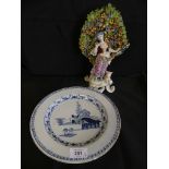 An 18th Century Delft circular plate, decorated in blue and white with a central panel of