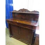 An early Victorian rosewood chiffonier With arched back section with single shelf and carved