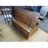 A contemporary hardwood hinged box coffee table, with an arrangement of twelve small drawers