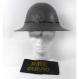 A grey painted British fireguard helmet, circa 1941 The Zuckerman grey painted helmet with inner